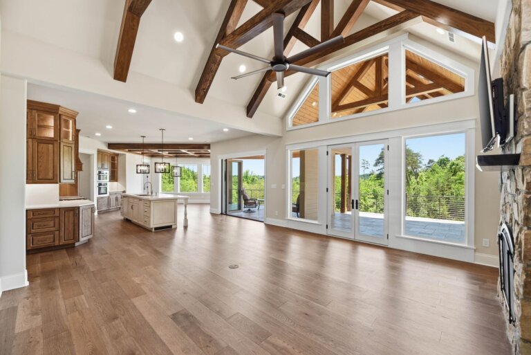 Knoxville custom home — open great room with timber-truss cathedral ceiling and wall of glass — Seigler Custom Homes