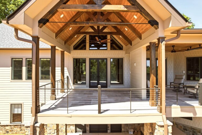 Knoxville custom home — vaulted timber-truss covered porch with cable railings overlooking the woods — Seigler Custom Homes
